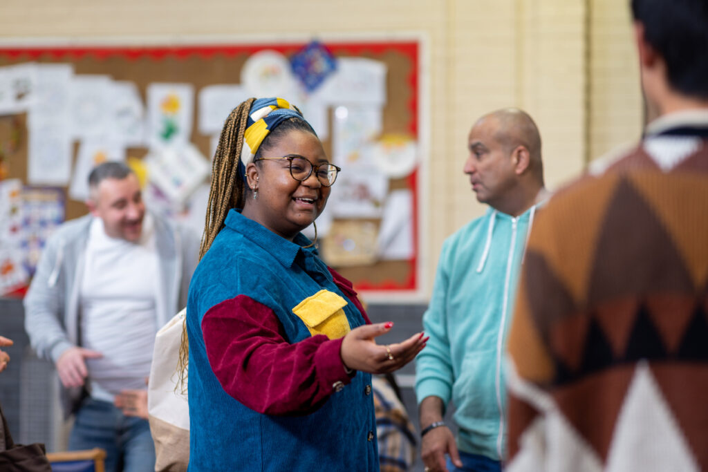 a group of adults ready to talk to each other about their mental well-being in a community centre