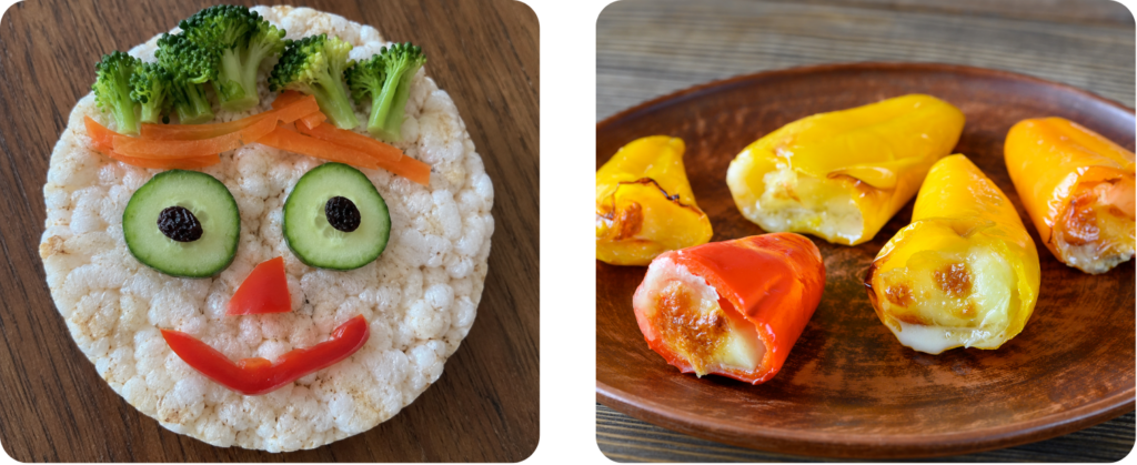 a rice cracker with a vegetable face and small peppers stuffed with cheese