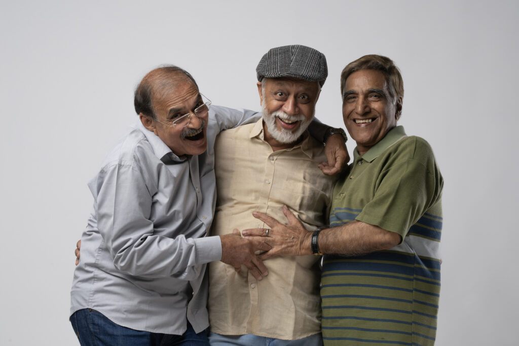 Three older men laughing together